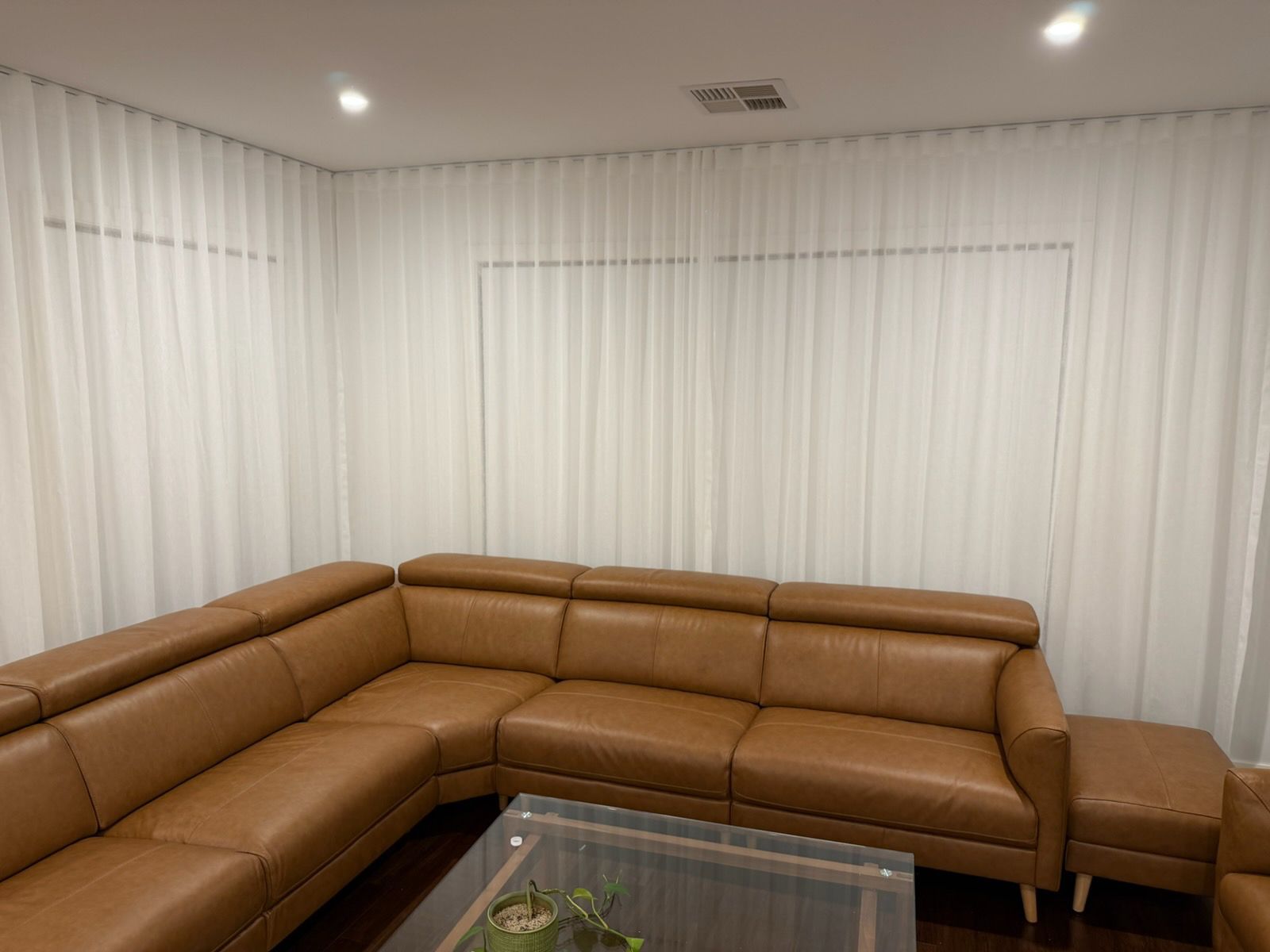 Custom blockout roller blinds installed in a bright modern home office