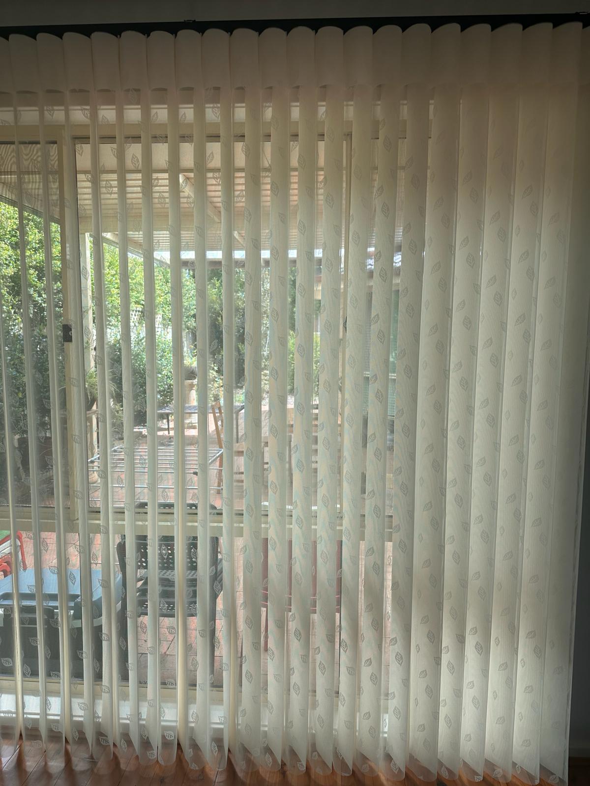 Custom blockout roller blinds installed in a bright modern home office